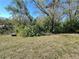 Landscaped backyard area showing mature trees and shrubs providing serene privacy for the home at 12205 Darwood Dr # 12205, Hudson, FL 34667