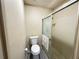 Bathroom with a toilet, sliding glass shower door and neutral-colored walls at 12205 Darwood Dr # 12205, Hudson, FL 34667