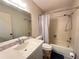 Well-lit bathroom featuring a vanity with ample counter space, a toilet, and a shower-tub combo with curtain at 12205 Darwood Dr # 12205, Hudson, FL 34667