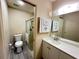 Bathroom featuring a vanity, toilet, and walk-in shower with glass door at 12205 Darwood Dr # 12205, Hudson, FL 34667
