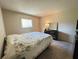 Bedroom featuring a large bed with quilt, black dresser with mirror, and natural light from the window at 12205 Darwood Dr # 12205, Hudson, FL 34667