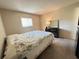 Bedroom featuring a large bed with quilt, black dresser with mirror, and natural light from the window at 12205 Darwood Dr # 12205, Hudson, FL 34667