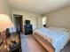 Bedroom showing the furnishings, closet, en-suite bathroom, and a view into the living room at 12205 Darwood Dr # 12205, Hudson, FL 34667