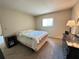 Bedroom featuring a large bed, dark furniture, and natural light from the window at 12205 Darwood Dr # 12205, Hudson, FL 34667