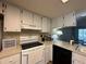 Bright kitchen boasts white cabinets, modern appliances, and ample counter space at 12205 Darwood Dr # 12205, Hudson, FL 34667