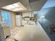 Well-lit kitchen featuring white appliances, abundant cabinet space, and tiled floors at 12205 Darwood Dr # 12205, Hudson, FL 34667