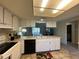 Functional kitchen featuring white cabinetry, a breakfast bar, and a seamless connection to the living area at 12205 Darwood Dr # 12205, Hudson, FL 34667