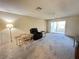 Inviting living room featuring neutral carpet, sliding doors to outdoor space, and a ceiling fan at 12205 Darwood Dr # 12205, Hudson, FL 34667