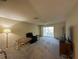 Spacious living room with neutral carpet, ceiling fan, and sliding door access to the outdoors at 12205 Darwood Dr # 12205, Hudson, FL 34667