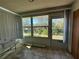 Enclosed sun room with tile flooring and natural light; perfect spot to relax and enjoy the outdoors at 12205 Darwood Dr # 12205, Hudson, FL 34667
