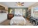 Bedroom with ceiling fan, musical instrument, and a big window at 12279 Penfield St, Spring Hill, FL 34609