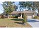 Charming single-story home featuring a well-manicured lawn and an attached one-car garage at 12279 Penfield St, Spring Hill, FL 34609