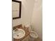 A clean half bathroom featuring a granite countertop and a well-maintained toilet at 12401 Joel Ct, Tampa, FL 33612