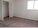 Spacious bedroom with a large window providing ample natural light and a closet at 12401 Joel Ct, Tampa, FL 33612