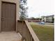 Townhouse entryway, with a wooden deck, and a view of the parking lot at 12401 Joel Ct, Tampa, FL 33612
