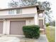 Charming townhouse featuring an attached garage and a cozy front entrance at 12401 Joel Ct, Tampa, FL 33612