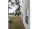 Side view of a townhouse, electrical, green lawn, window, and palm trees in the background at 12401 Joel Ct, Tampa, FL 33612