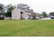 Townhouses with green lawns, driveways, and well-maintained exteriors at 12401 Joel Ct, Tampa, FL 33612