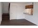 The living room has wood floors, white walls, and a kitchen view with granite countertops at 12401 Joel Ct, Tampa, FL 33612