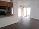 A bright living room features wood floors and a sliding door to the outside at 12401 Joel Ct, Tampa, FL 33612