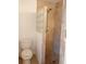 Shower stall clad in stone tile with modern fixtures and a decorative glass block wall at 12401 Joel Ct, Tampa, FL 33612