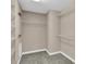 Walk-in closet with neutral walls, carpet and wire shelves at 13011 Western Cir, Hudson, FL 34667