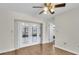 This bright living room has beautiful floors and glass doors that lead to the lanai at 13011 Western Cir, Hudson, FL 34667