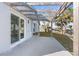 Relaxing back patio with modern pergola, leading to the waterfront backyard with mature palm trees at 13726 Michelle Ave, Hudson, FL 34667