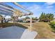 Spacious backyard featuring a wooden pergola with canal access at 13726 Michelle Ave, Hudson, FL 34667