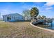 Backyard featuring a home with a dock and waterfront access at 13726 Michelle Ave, Hudson, FL 34667