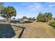 Waterfront backyard with lush palms, boat lift, and serene views of canal at 13726 Michelle Ave, Hudson, FL 34667