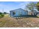 Backyard featuring a home with a pergola and mature trees at 13726 Michelle Ave, Hudson, FL 34667