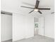 Bright bedroom with a ceiling fan, tile flooring, and a closet with sliding doors at 13726 Michelle Ave, Hudson, FL 34667