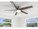 Bedroom featuring a modern ceiling fan with integrated lighting and views from updated windows at 13726 Michelle Ave, Hudson, FL 34667