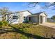 Beautiful single-Gathering home featuring stone accents, a well-manicured lawn, and a driveway leading to the garage at 13726 Michelle Ave, Hudson, FL 34667