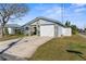 Charming single-Gathering home featuring a stone facade, well-kept lawn, and a driveway leading to a single-car garage at 13726 Michelle Ave, Hudson, FL 34667