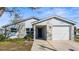 Charming home featuring a stone facade, an attached garage, and freshly manicured lawn at 13726 Michelle Ave, Hudson, FL 34667