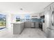Open concept kitchen with island, stainless steel appliances and tile flooring at 13726 Michelle Ave, Hudson, FL 34667