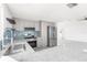 Modern kitchen features stainless steel appliances, granite countertops and grey cabinets at 13726 Michelle Ave, Hudson, FL 34667
