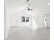 Bright living room with vaulted ceilings and neutral tile flooring; lots of natural light at 13726 Michelle Ave, Hudson, FL 34667