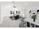 Open-concept living space with modern furnishings, vaulted ceilings, and ample natural light at 13726 Michelle Ave, Hudson, FL 34667