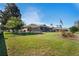 Backyard view with grass, flowers, and flagpole at 14251 Mansfield Rd, Spring Hill, FL 34609