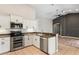 Modern kitchen with stainless steel appliances, granite countertops, and white cabinets at 14251 Mansfield Rd, Spring Hill, FL 34609