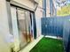 Backyard with a sliding glass door and synthetic turf at 14736 Norwood Oaks Dr # 103, Tampa, FL 33613