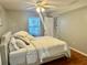 Bright bedroom featuring wood flooring, a ceiling fan, and a large window at 14736 Norwood Oaks Dr # 103, Tampa, FL 33613