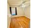 Bedroom with hardwood flooring, ceiling fan, and large window at 14736 Norwood Oaks Dr # 103, Tampa, FL 33613