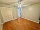 Spacious bedroom featuring wood flooring, a ceiling fan, and closet at 14736 Norwood Oaks Dr # 103, Tampa, FL 33613