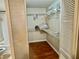 Spacious walk in closet with wood floors, wire shelves, and room for organization at 14736 Norwood Oaks Dr # 103, Tampa, FL 33613