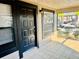 Welcoming front door of the home featuring sleek black hardware and a convenient window for natural light at 14736 Norwood Oaks Dr # 103, Tampa, FL 33613