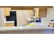 Efficient kitchen design featuring stainless steel appliances, wooden cabinets, and a breakfast bar at 14736 Norwood Oaks Dr # 103, Tampa, FL 33613
